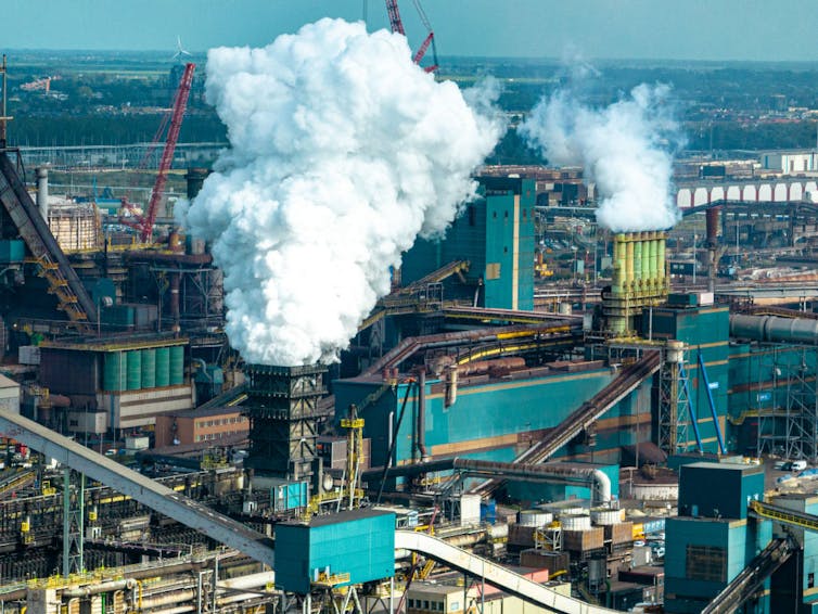 steam billows from an industrial plant