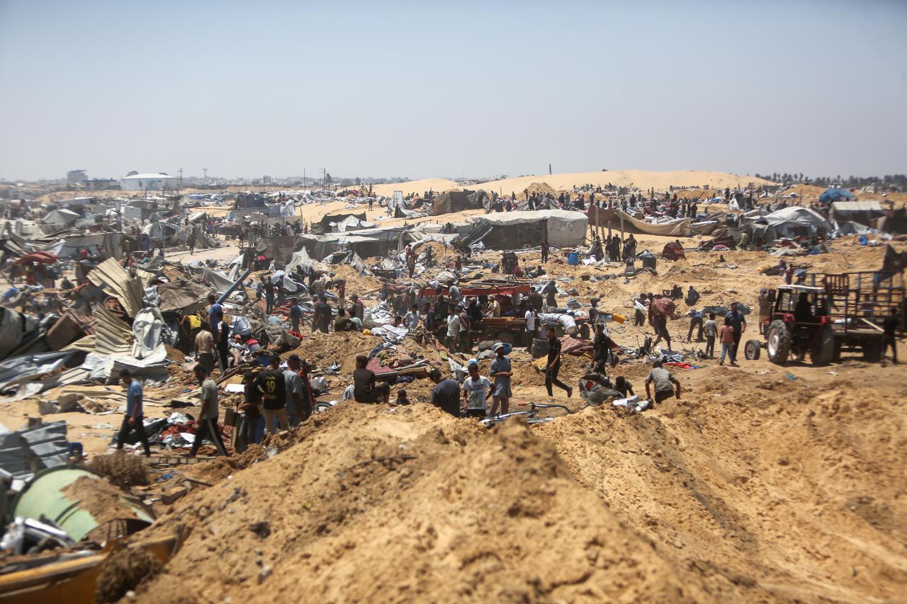 Palestinians inspect destruction at a makeshift displacement camp following a incursion by Israeli tanks in Khan Yunis, southern Gaza strip on July 11, 2025. (AFP Photo)
