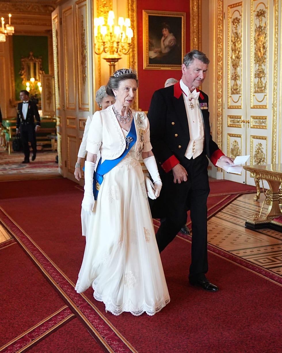 Formal event featuring elegantly dressed individuals in a grand interior