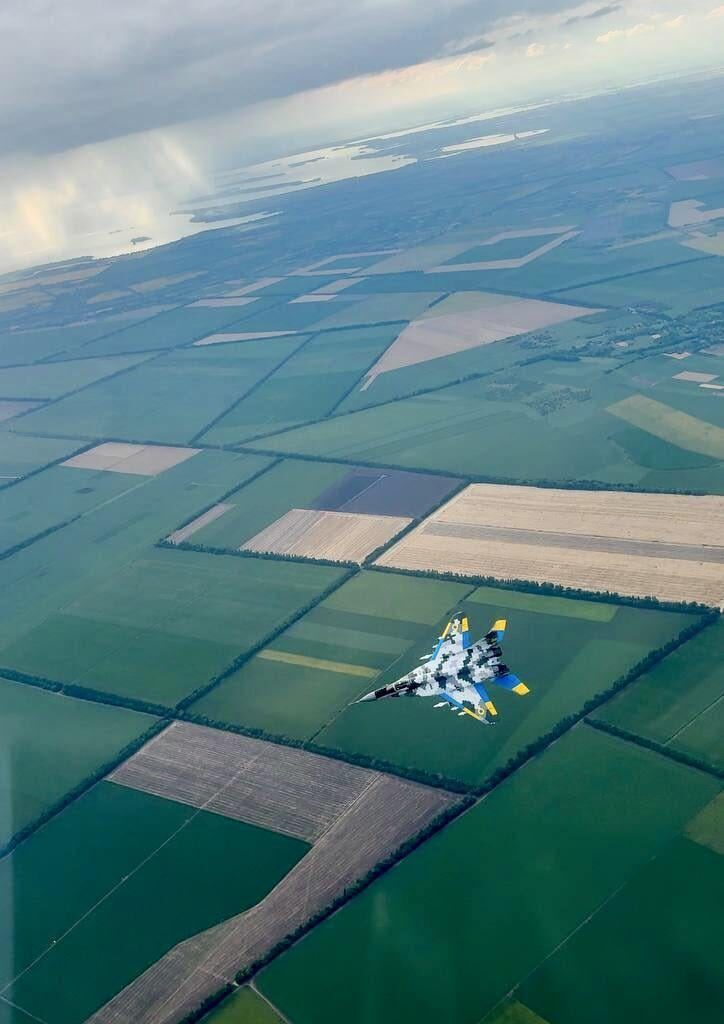 Mikoyan MiG-29 'Fulcrum' multirole fighter jet in digital camouflage with an air-to-air loadout, from the Ukrainian Air Force - over the green countryside of the Poltava Oblast.