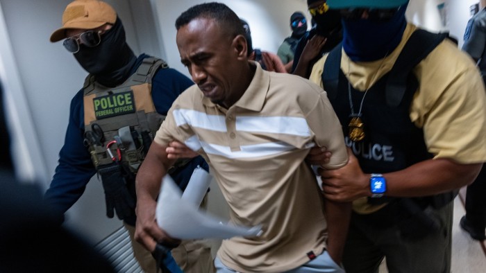 Federal agents, including members of ICE, drag a man away after his court hearing in New York