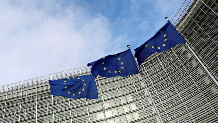 Three EU flags flying outside the European Commission building in Brussels, Belgium