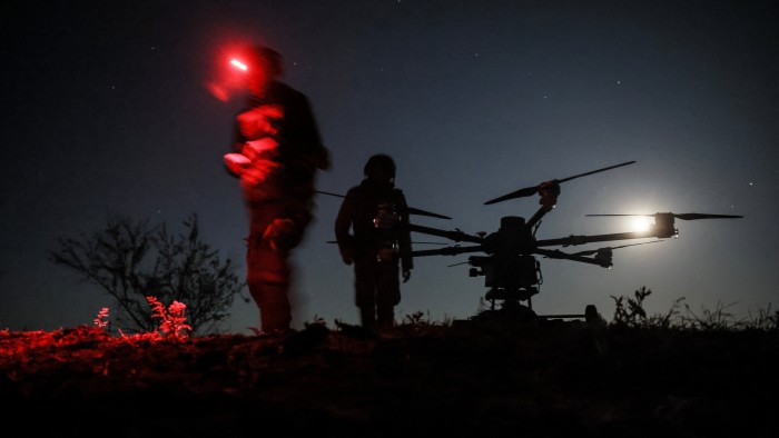 Ukraine troops prepare to fly a drone