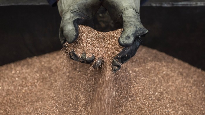 Worker handles copper shavings