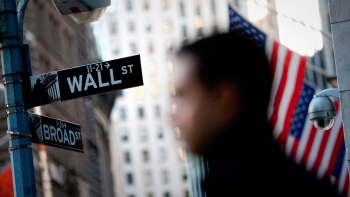 A close-up of a Wall Street street sign