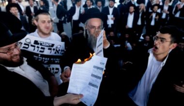 Ultraorthodox Jewish men burn conscription orders during a protest last month in Bnei Brak