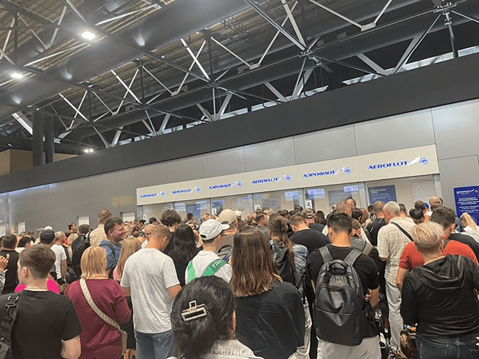 Long line of people at Aeroflot check-in counters.
