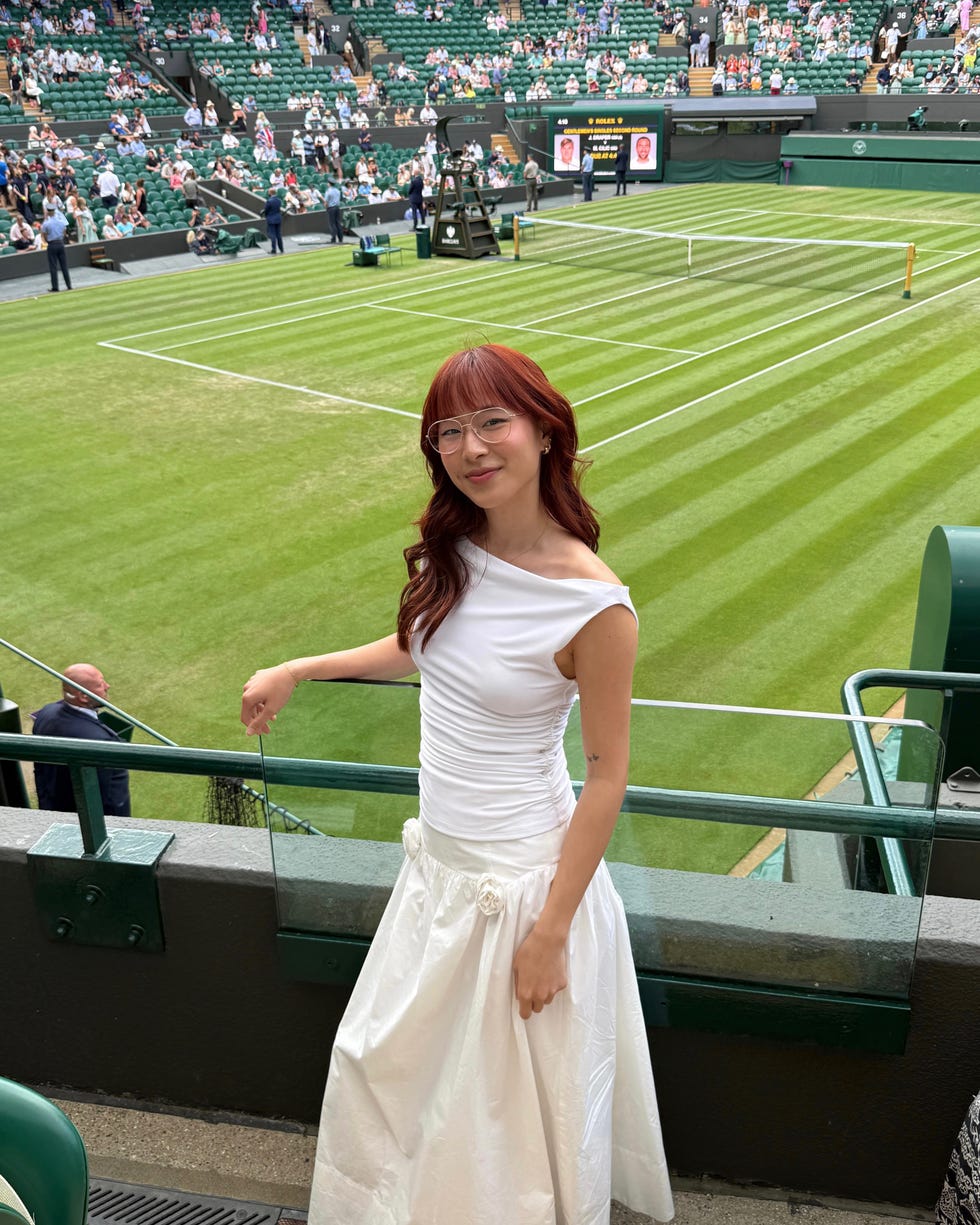 a person dressed in formal attire at a tennis match during wimbledon