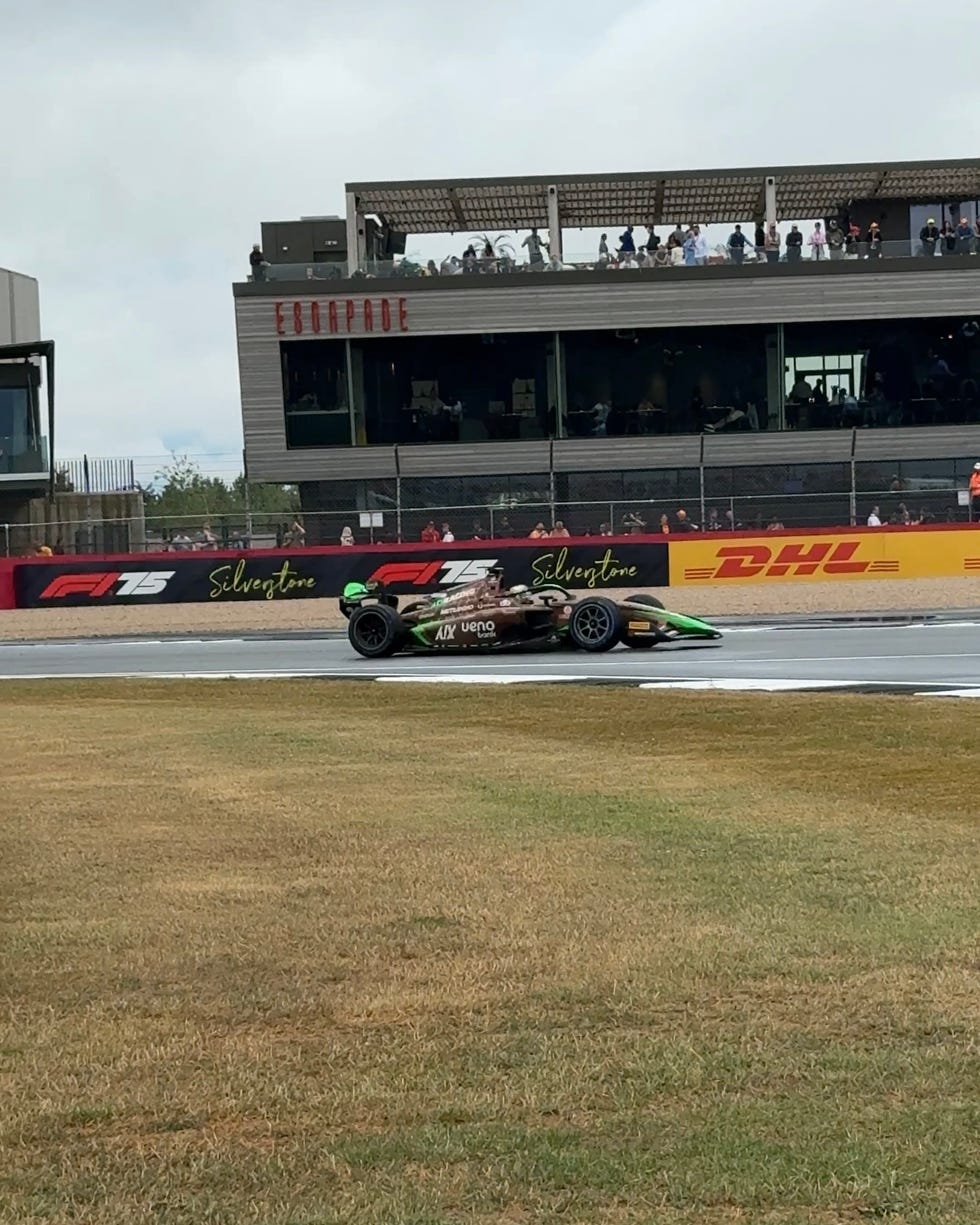 an f1 car drives through the racetrack.