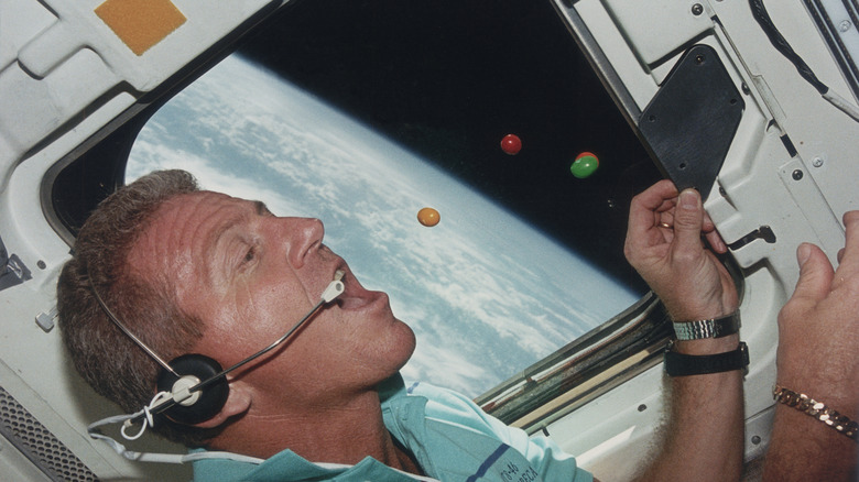 astronaut eating candy in space shuttle