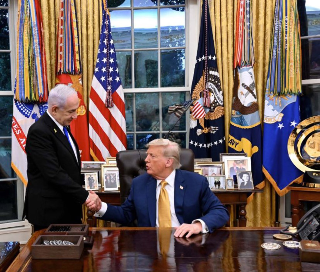 Benjamin Netanyahu and Donald Trump shaking hands in the Oval Office.