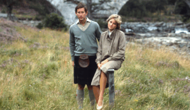 Prince Charles and Princess Diana on honeymoon at Balmoral standing in the grass along the river