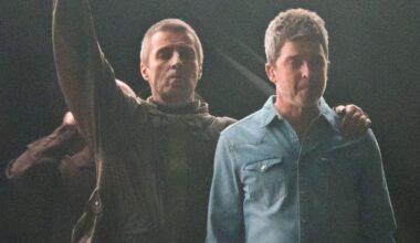 Liam and Noel Gallagher embrace on stage as brothers reunite for Oasis tour