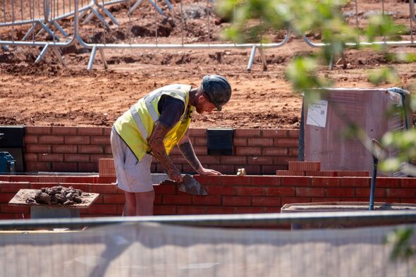 A bricklayer at a building site in Devon