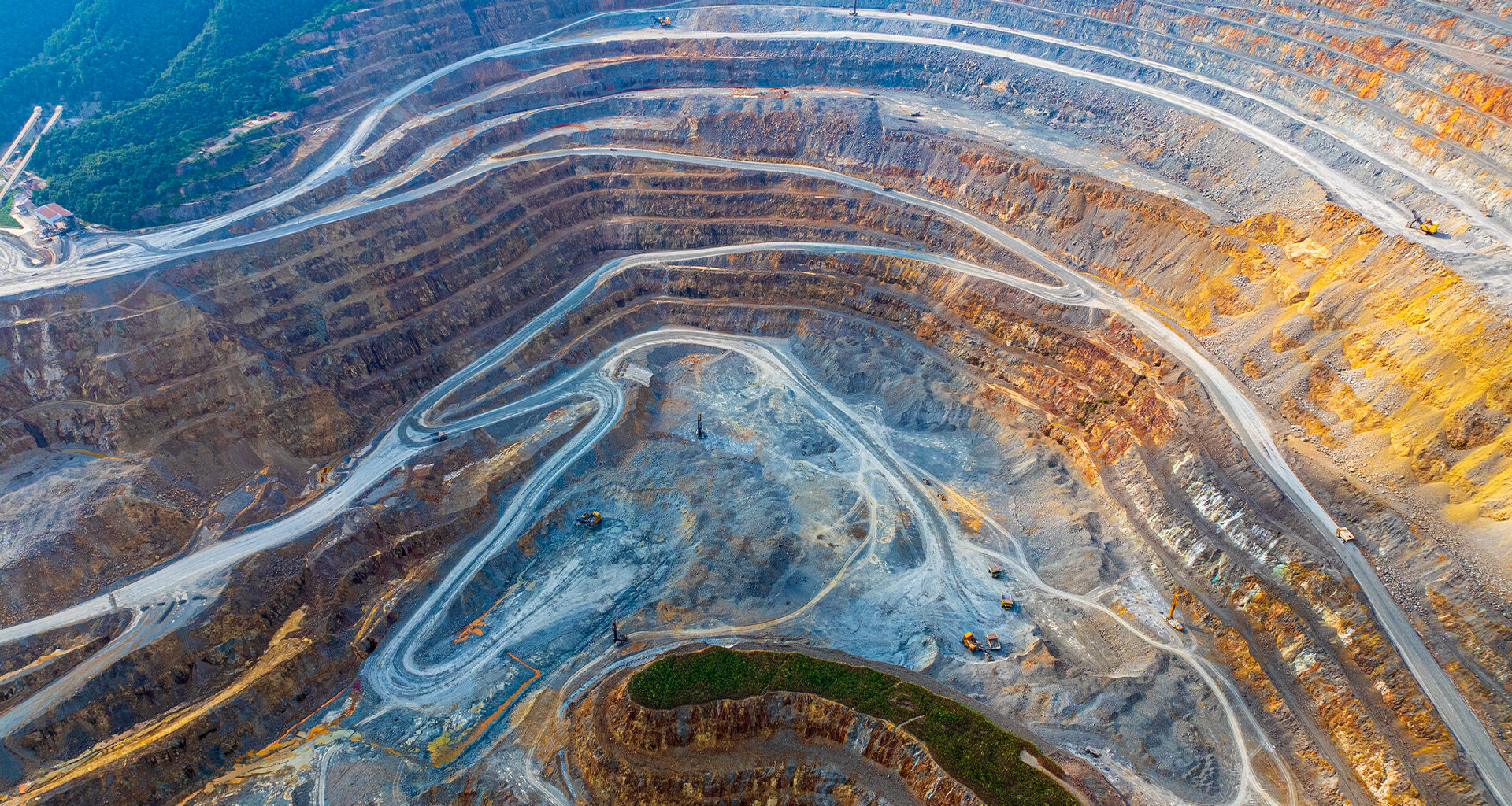 Aerial view of excavators and transport vehicles busy with work at Dexing Copper Mine on August 16, 2024 in Shangrao, Jiangxi Province of China.