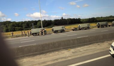 British army at a tipped over semi truck