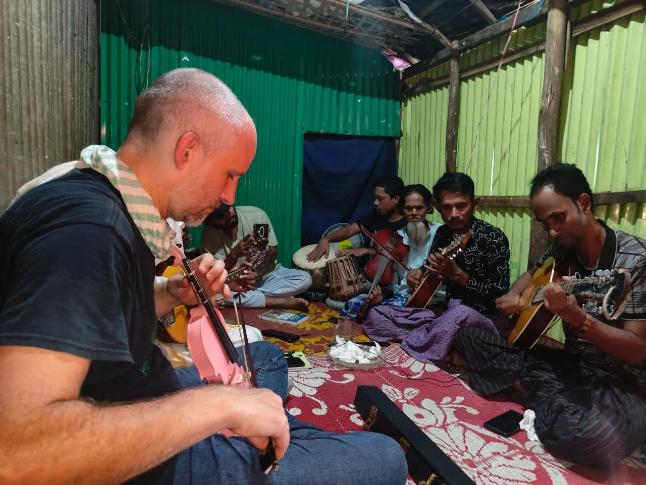 Rohingya refugee musicians and Crossing Borders co-director Tom Clowes gathered together for cultural exchange and learning.