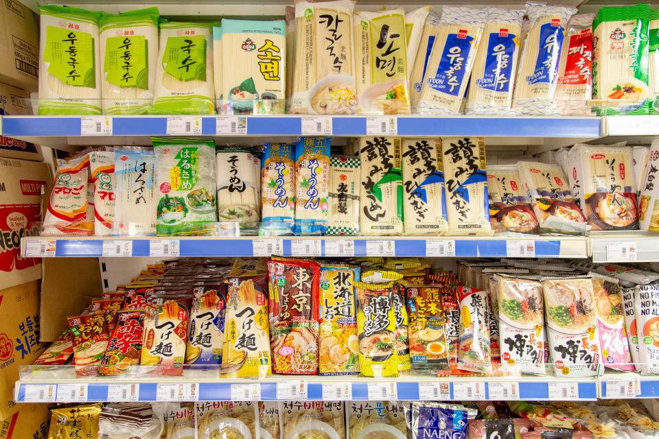 Japanese and Korean noodles on supermarket shelves.