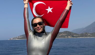 National athlete Sahika Ercumen poses with Turkish flag in hand during the Free Diving Open Water Seniors and Masters Individual Türkiye Championship held in Antalya, Türkiye, July 20, 2025. (AA Photo)