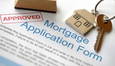 Approved mortgage loan application with house key and rubber stamp