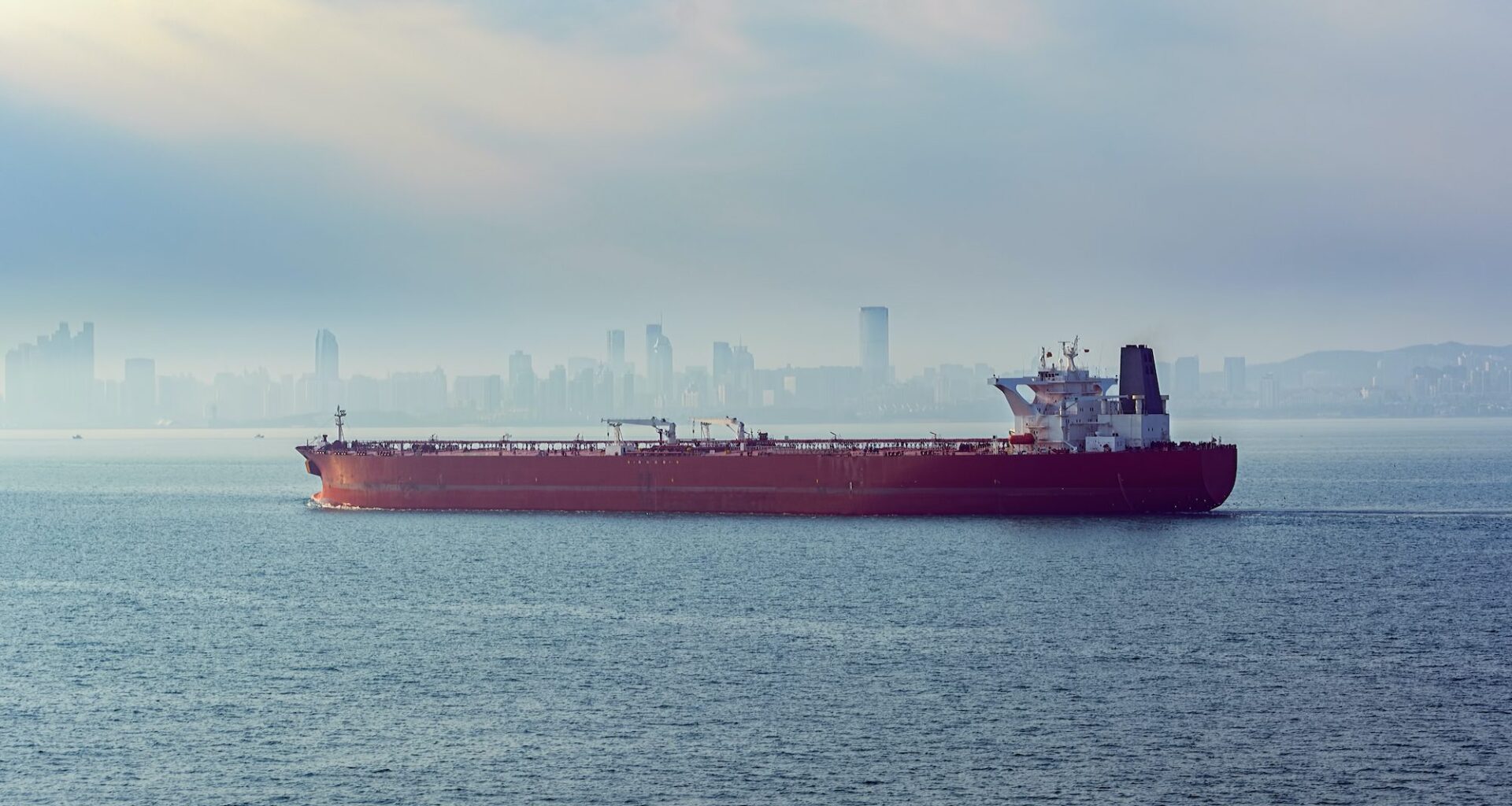 Laden crude oil tanker approaches the port of Qingdao, China in the morning fog. Photo credit: Shutterstock/Igor Grochev