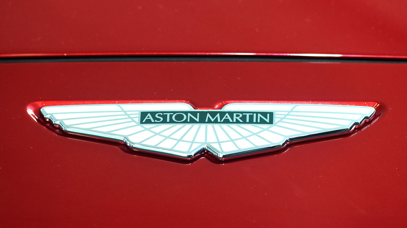 The Prince of Wales places a logo on the new Aston Martin DBX at the new Aston Martin Lagonda factory in Barry, Wales.