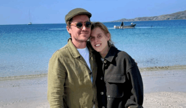 Princess Beatrice and Edoardo Mapelli Mozzi wearing green jackets on the beach and smiling