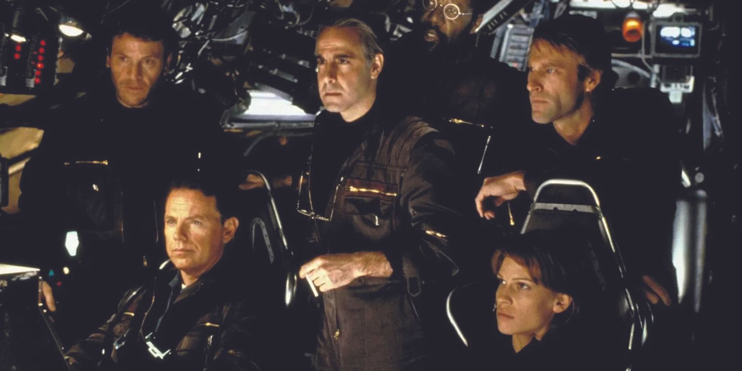The cast of 2003's The Core standing together in a cockpit 