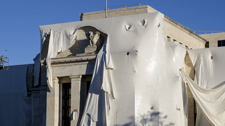 The sculpture of an eagle looks out from behind protective construction wrapping on the facade as the Federal Reserve Board Building undergoes both interior and exterior renovations.