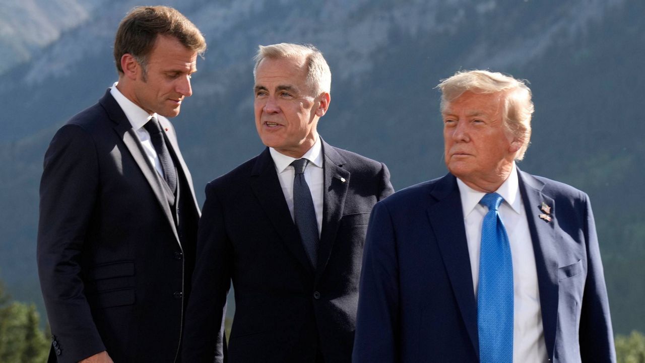 From left, French President Emmanuel Macron, Canadian Prime Minister Mark Carney and President Donald Trump arrive for the family photograph during the G7 Summit in Kananaskis, Alberta, June 16, 2025. (Adrian Wyld/The Canadian Press via AP, File)