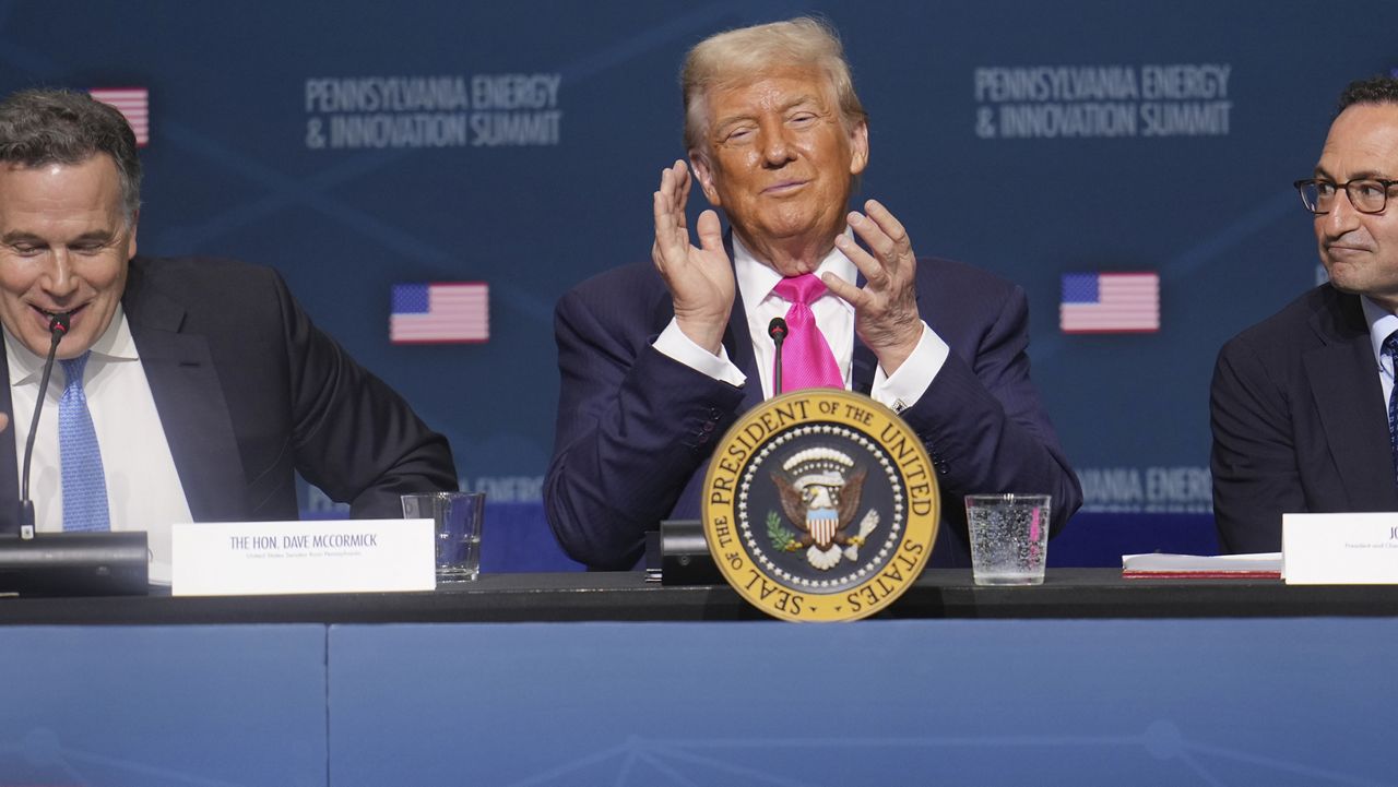 President Donald Trump, center, seated with Sen. Dave McCormick, R-Pa., left, and Jon Gray, President and Chief Operating Officer, Blackstone, right, at the "Inaugural Pennsylvania Energy and Innovation Event" at Carnegie Mellon University, Tuesday, July 15, 2025, in Pittsburgh. (AP Photo/Gene J. Puskar)