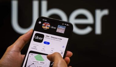 A person looking at the Uber app on a smartphone.