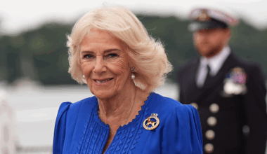 Queen Camilla wearing a blue dress and smiling