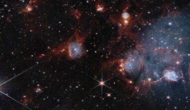 a photo of blue and orange cloudy shapes in outer space with countless twinkling stars