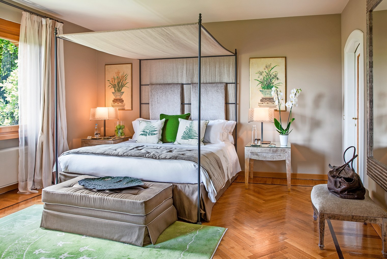 Hotel bedroom with four-poster bed.
