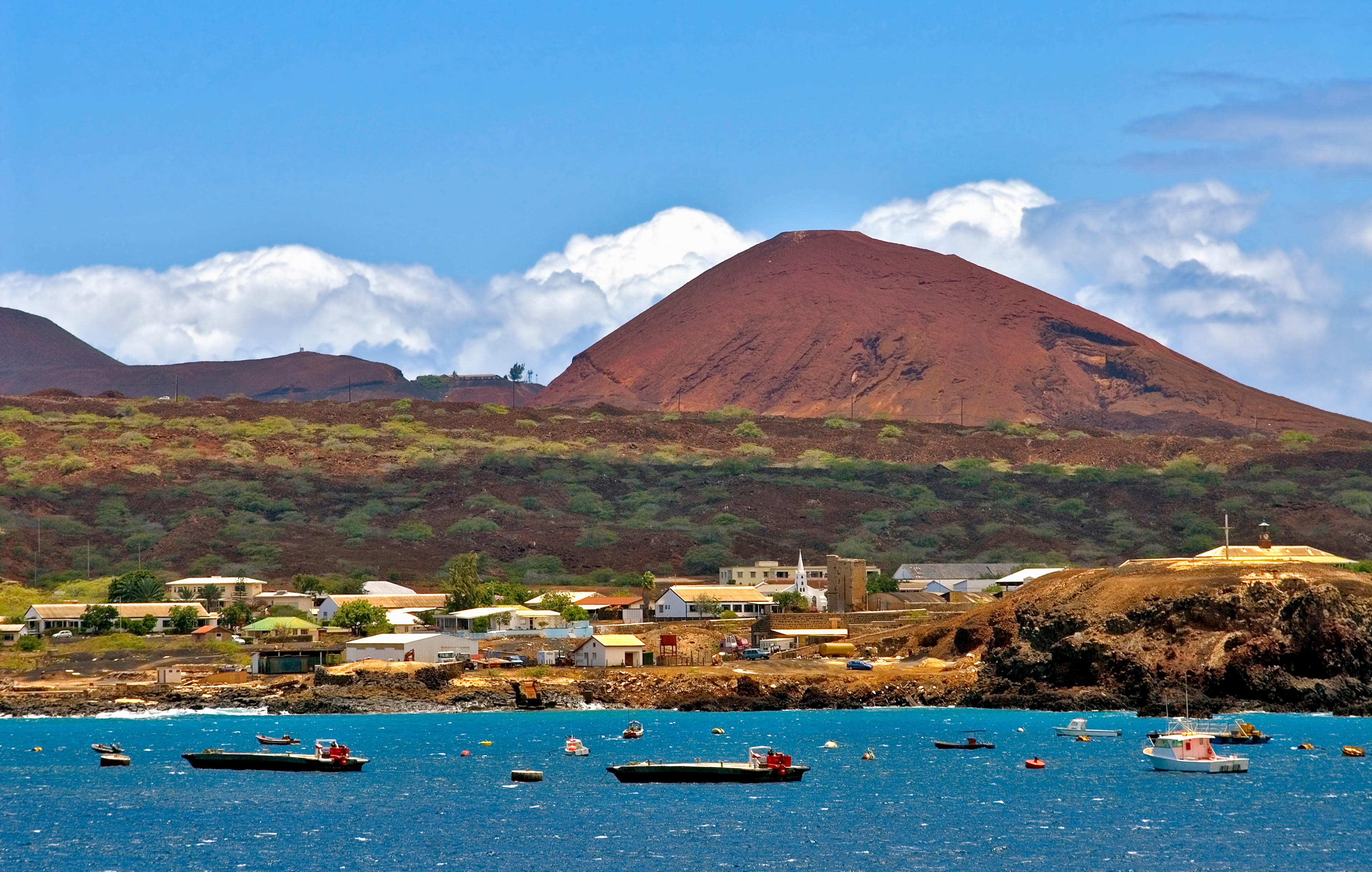 Georgetown, Ascension Island, with boats in the harbor and a volcano in the background.