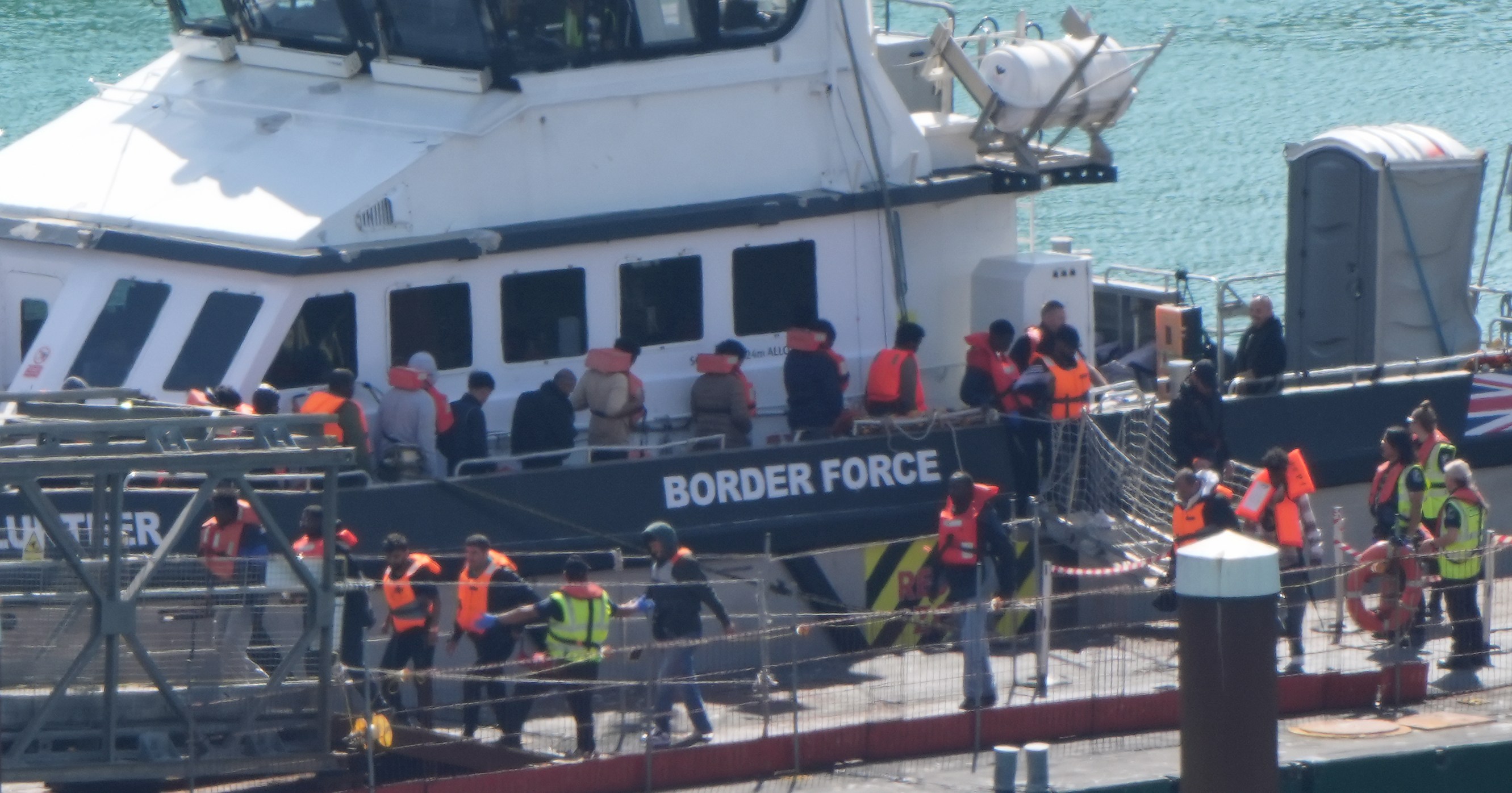 Migrants arriving at a Border Force compound in Dover.