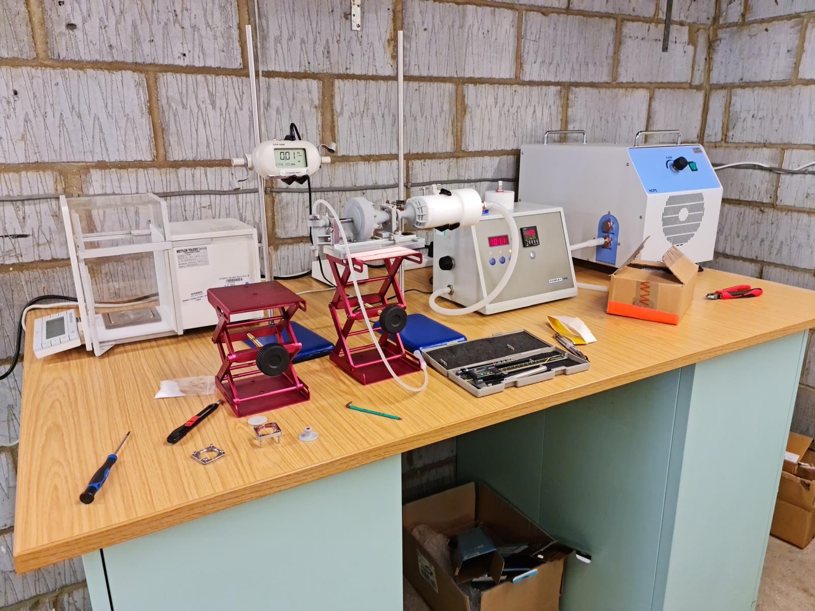 Lab bench with scientific equipment and tools.