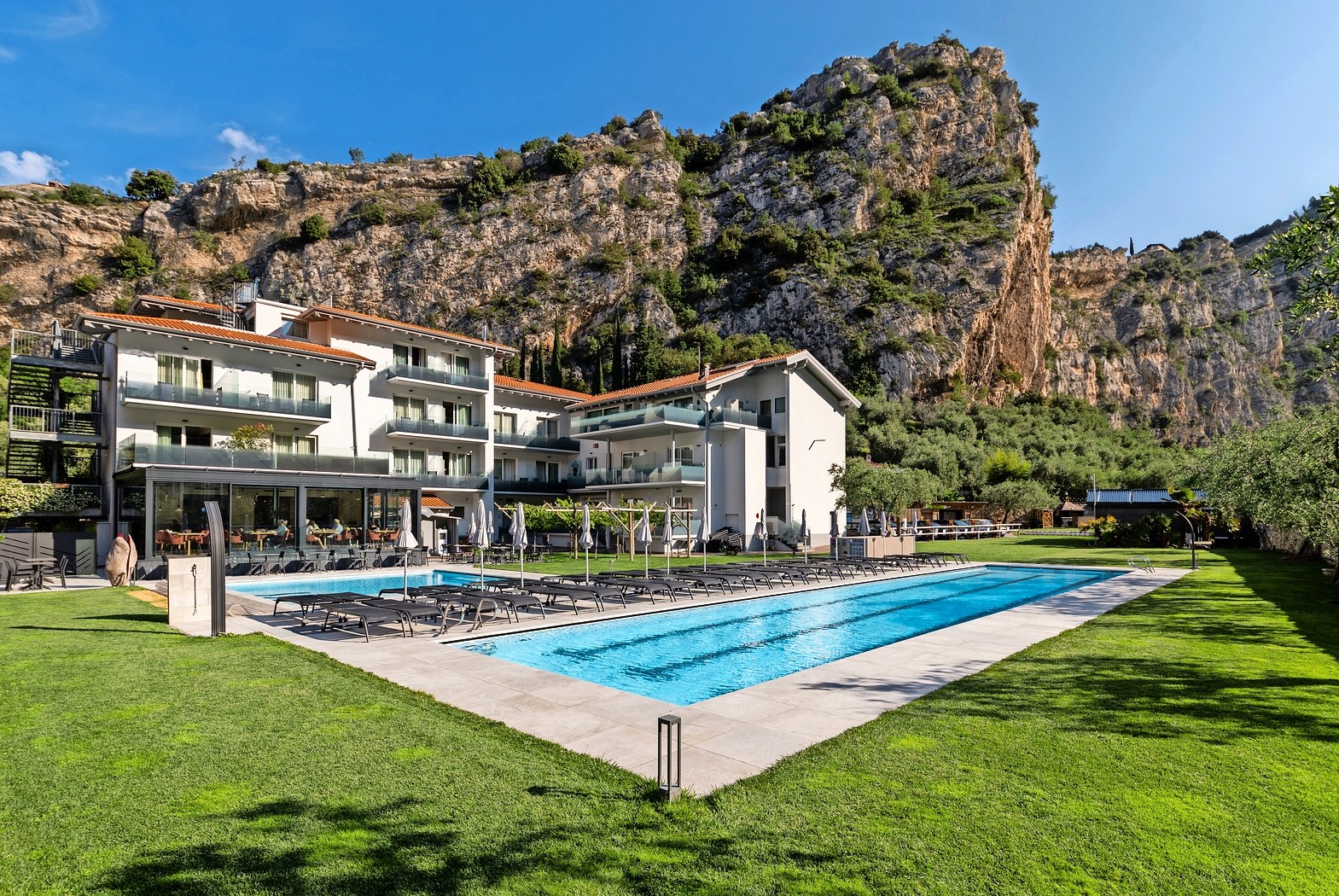 AktivHotel SantaLucia in Torbole, Garda, Italy, with pool and mountain backdrop.