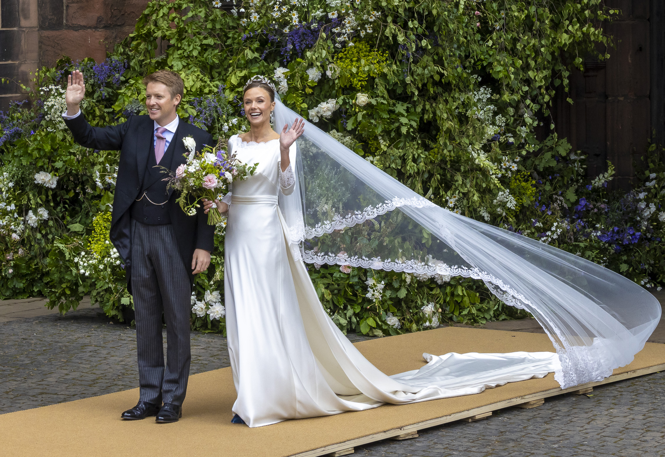 The Duke of Westminster and Olivia Henson waving after their wedding at Chester Cathedral.