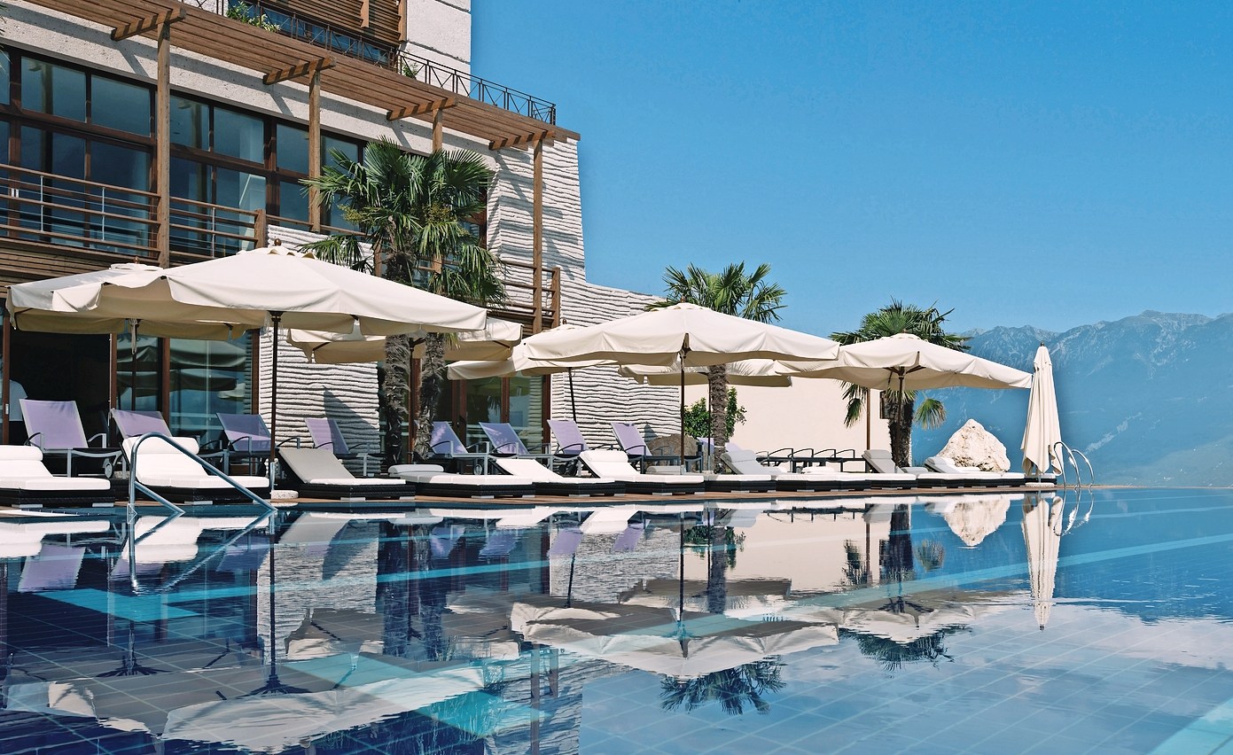 Infinity pool and lounge chairs at a resort.