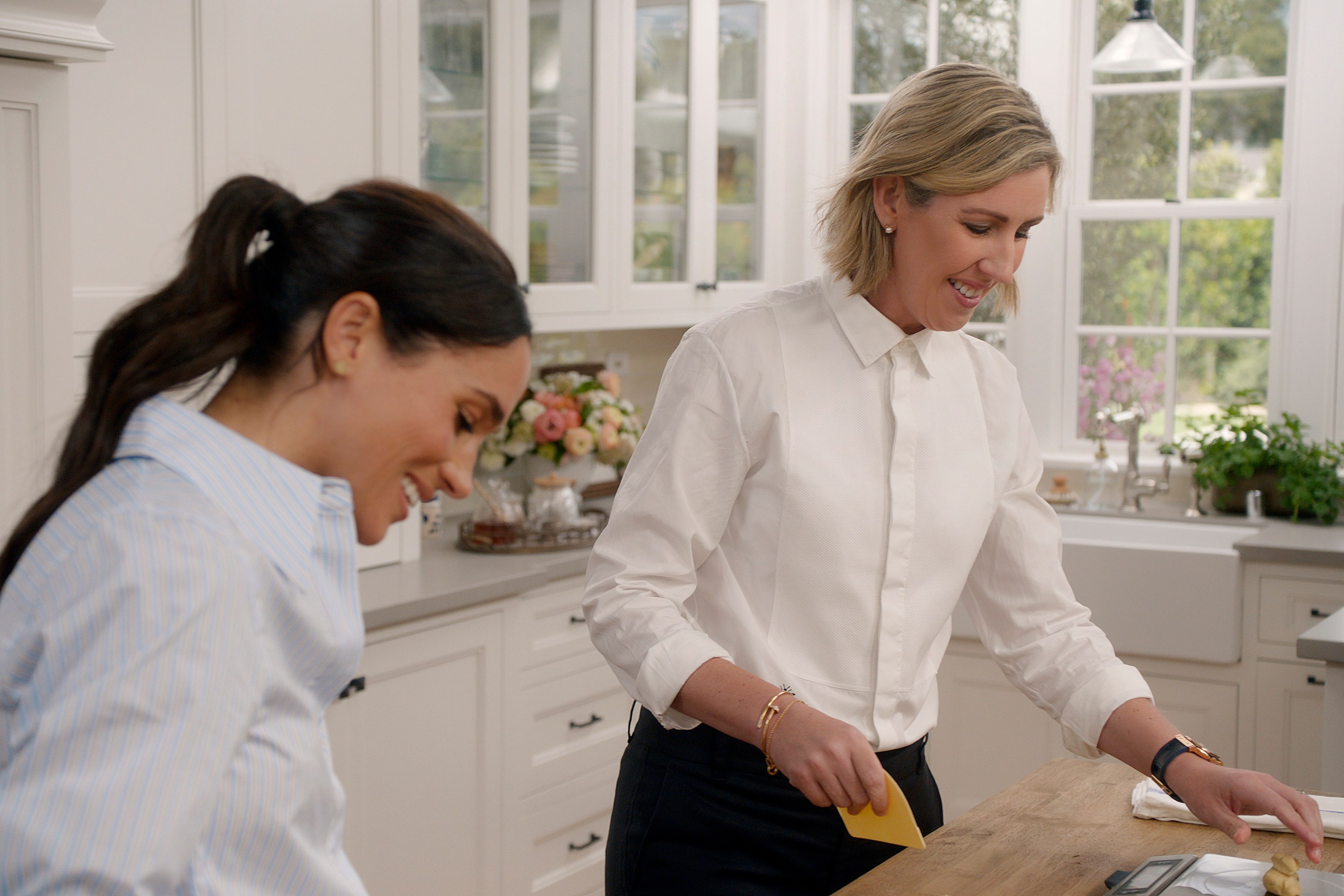Meghan Markle and Clare Smyth in a kitchen scene from *With Love, Meghan*.