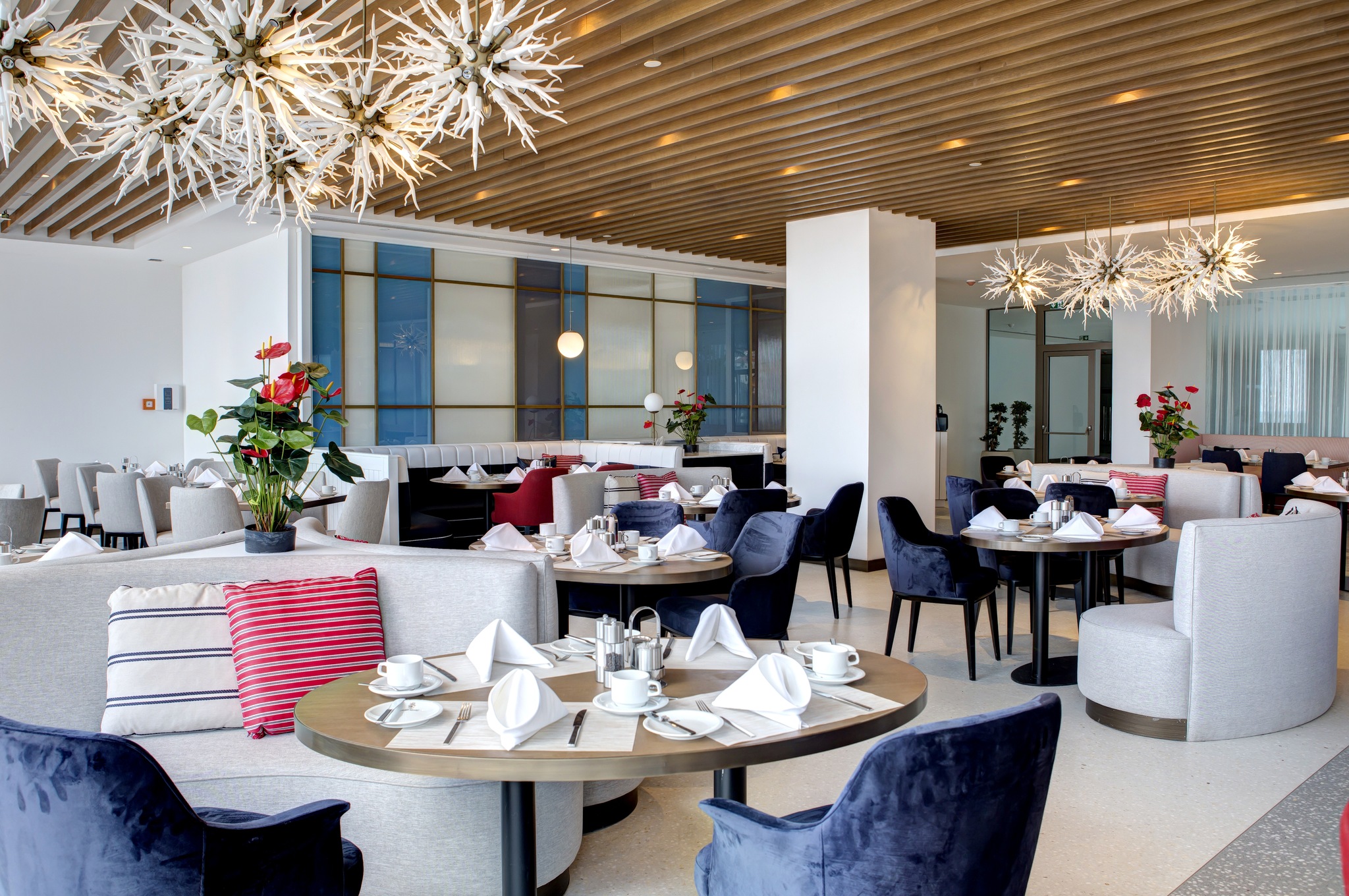 Interior view of a restaurant with tables set for breakfast.