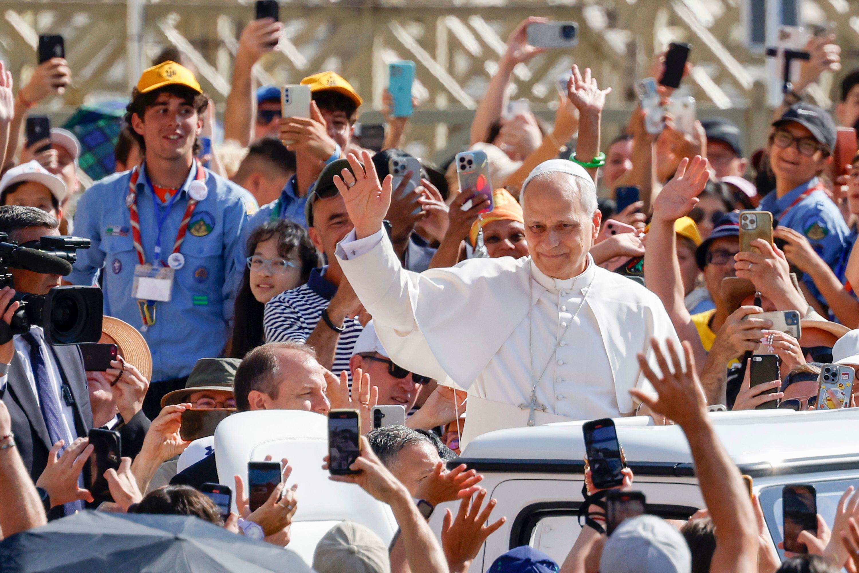 Pope Leo XIV waving to a crowd.