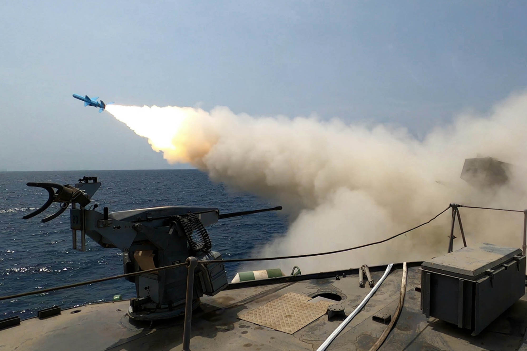 Missile launch from Iranian vessel during military drills in the Sea of Oman.