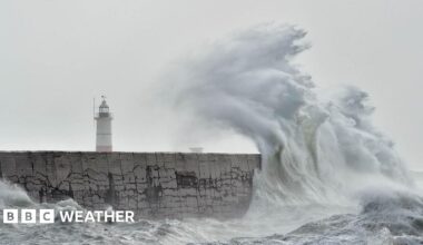 Large waves crashing on Newhaven Breakwater Light at Newhaven Harbour, East Sussex