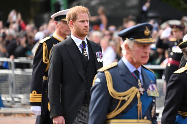 Sir Timothy Laurence, Prince Harry, Duke of Sussex and King Charles III walk behind the coffin during the procession for the Lying-in State of Queen Elizabeth II on September 14, 2022