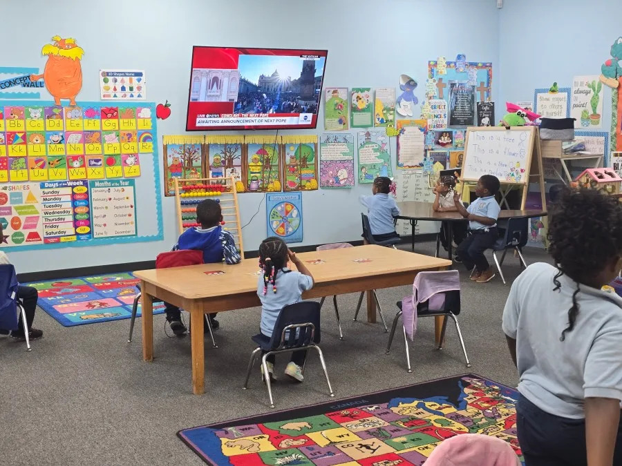 Principal Chris Payne and Pre-K students watching the announcement of Pope Leo XIV in May 2025 (Courtesy: Chris Payne)