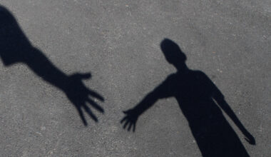 An image shows a child reaching out to seek help. [SHUTTERSTOCK]