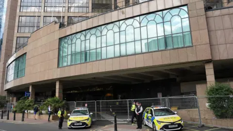 PA Media Police outside the Britannia International Hotel in Canary Wharf, London during an Abolish Asylum System demonstration. 